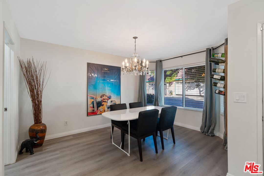 17221 Roscoe Boulevard, Unit 11 Northridge, CA 91325 - Photo 9 of 38 a view of a dining room with furniture window and wooden floor