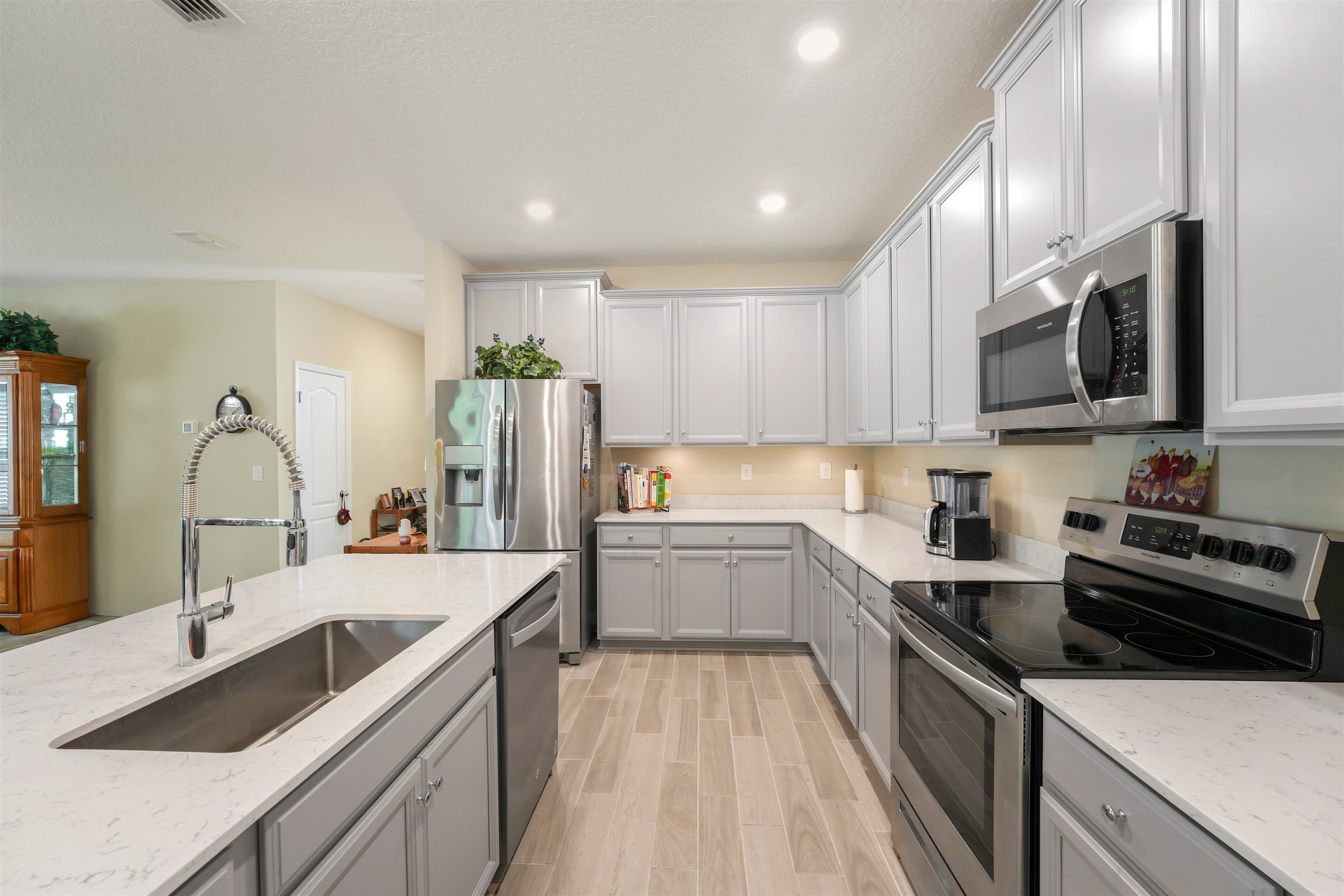 503 Stone Arbor Lane St. Augustine, FL 32086 - Photo 11 of 44 a kitchen with a sink stove top oven and refrigerator