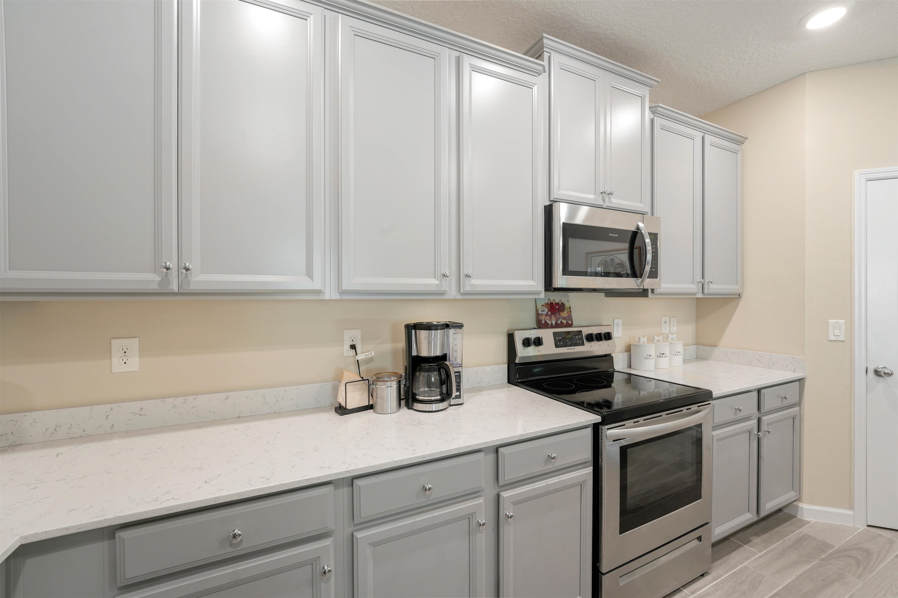 503 Stone Arbor Lane St. Augustine, FL 32086 - Photo 13 of 44 a kitchen with white cabinets and white appliances