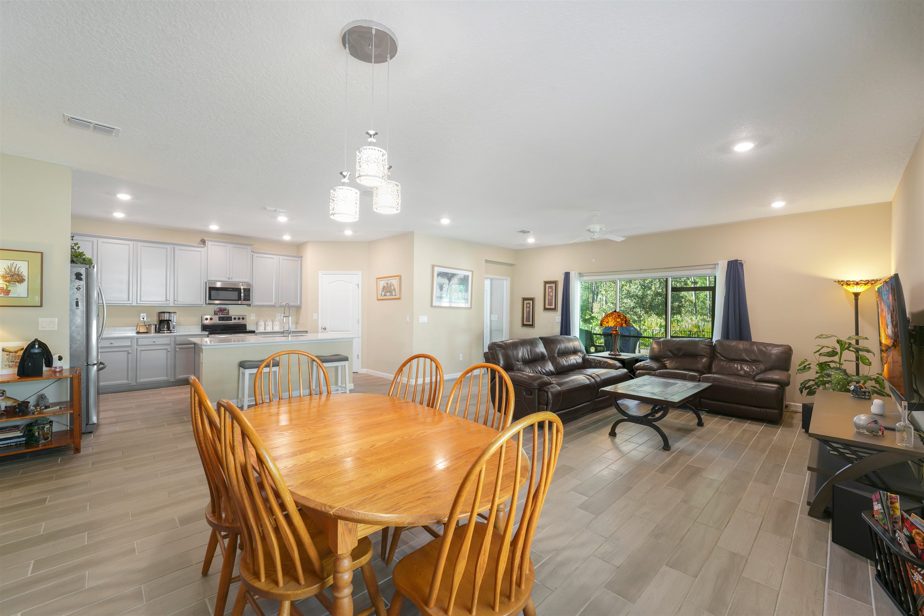 503 Stone Arbor Lane St. Augustine, FL 32086 - Photo 20 of 44 a view of a dining room and livingroom with furniture wooden floor a chandelier