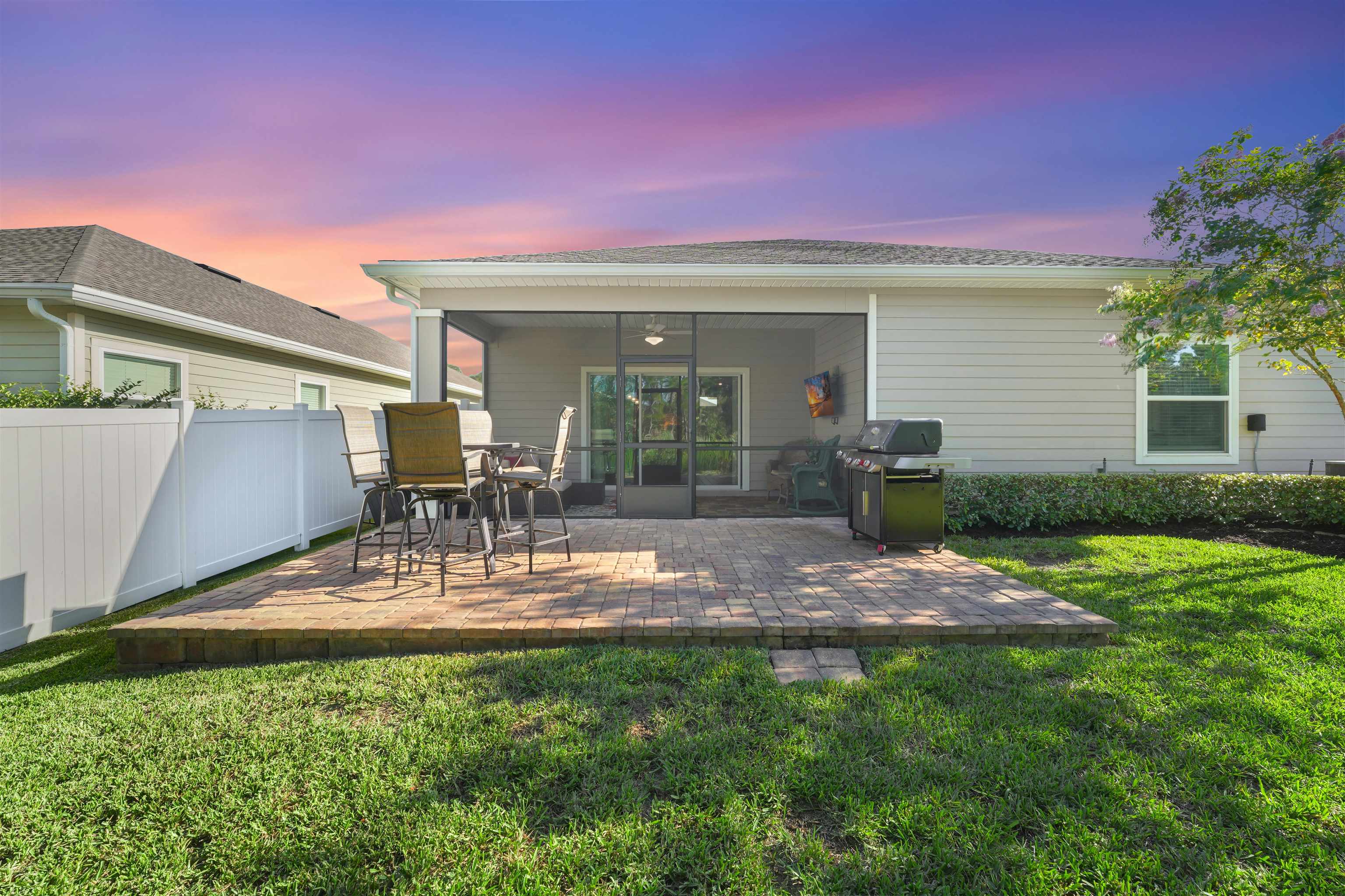 503 Stone Arbor Lane St. Augustine, FL 32086 - Photo 37 of 44 Back of house at dusk featuring a patio area