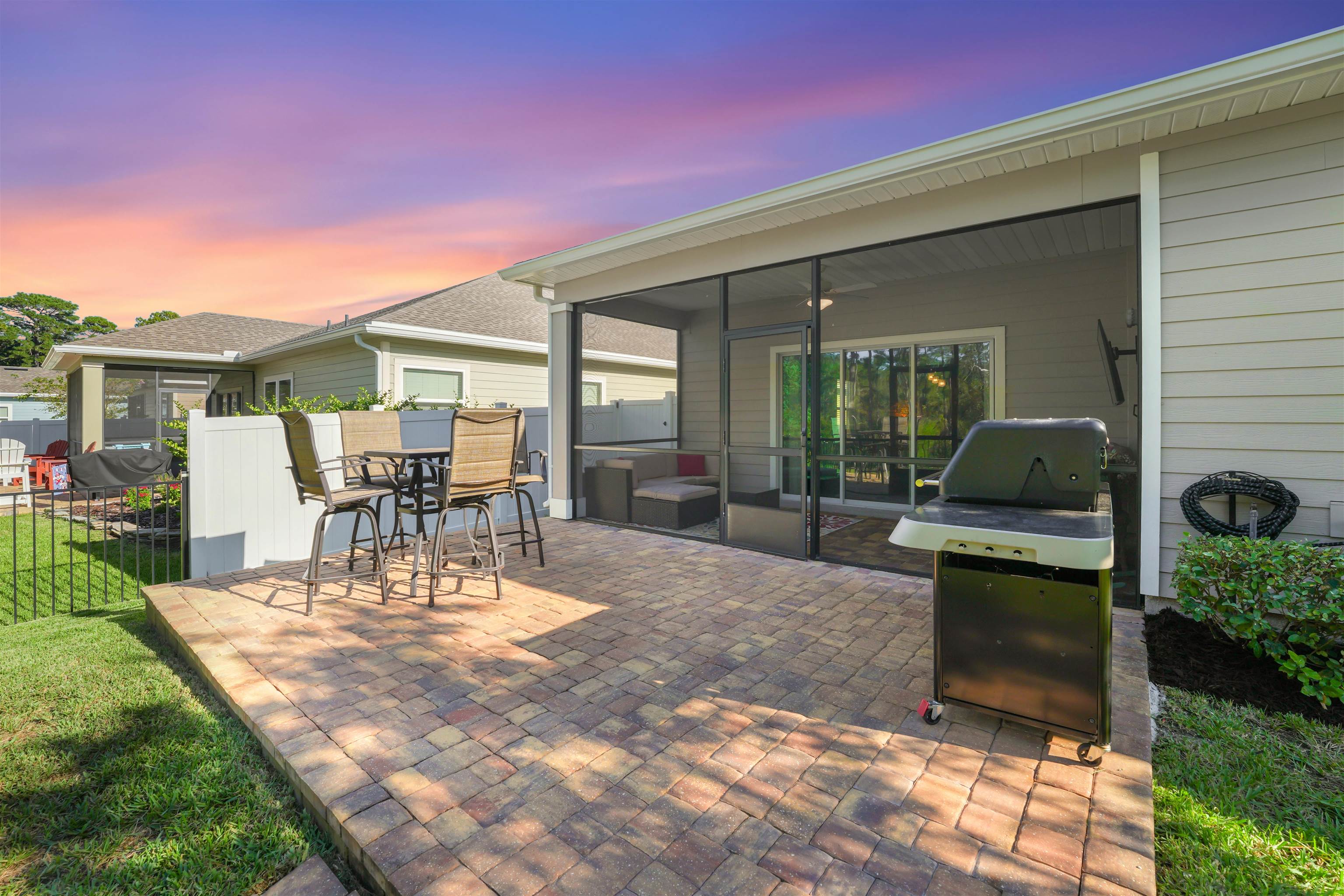 503 Stone Arbor Lane St. Augustine, FL 32086 - Photo 38 of 44 Patio terrace at dusk featuring grilling area, a sunroom, a patio area, and outdoor dining area