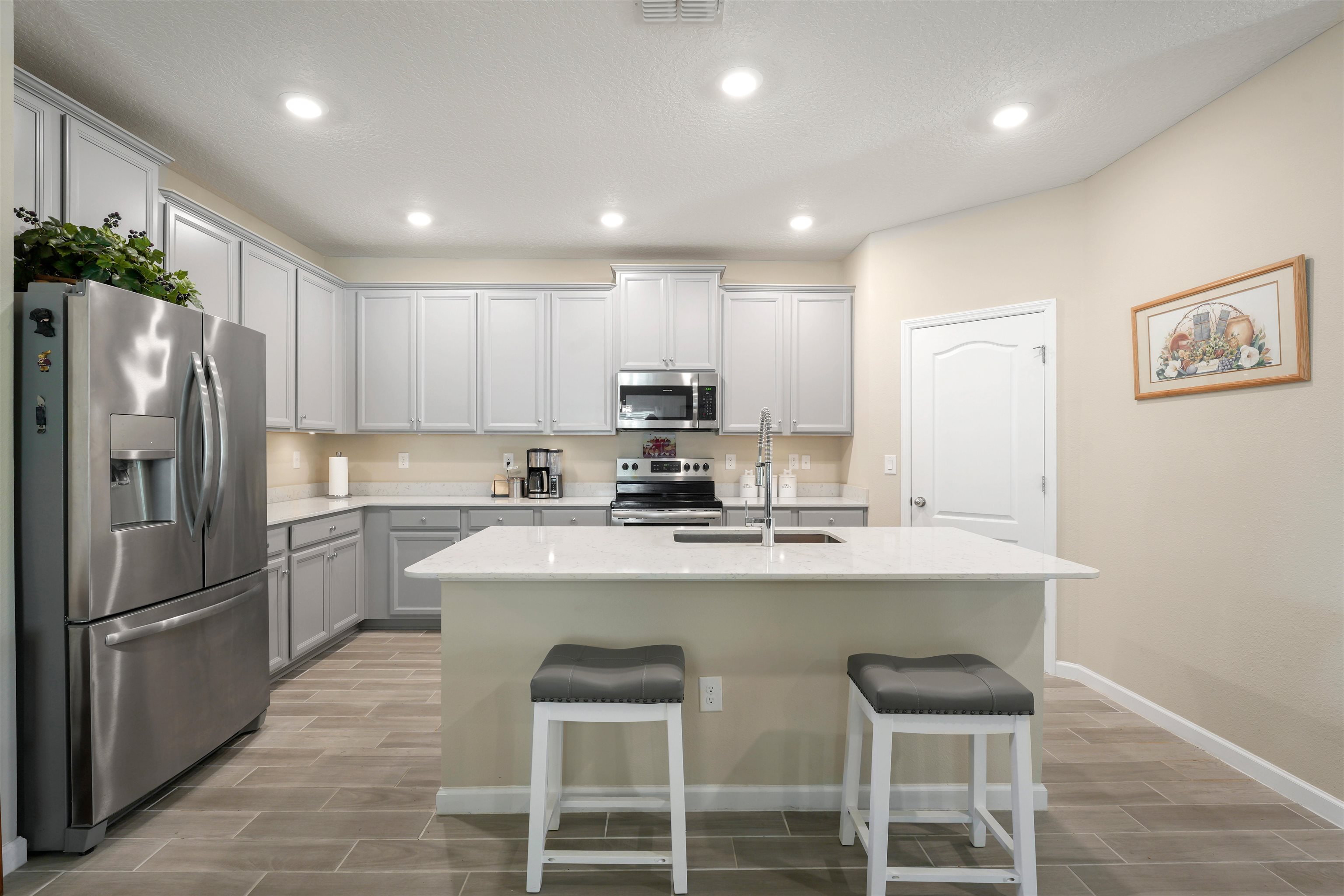 503 Stone Arbor Lane St. Augustine, FL 32086 - Photo 10 of 44 a kitchen with kitchen island a refrigerator stove and microwave