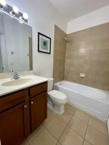 a bathroom with a toilet a sink and bathtub