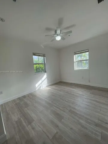 wooden floor with a bathroom