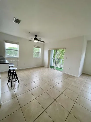 a view of a yard with a wooden fence