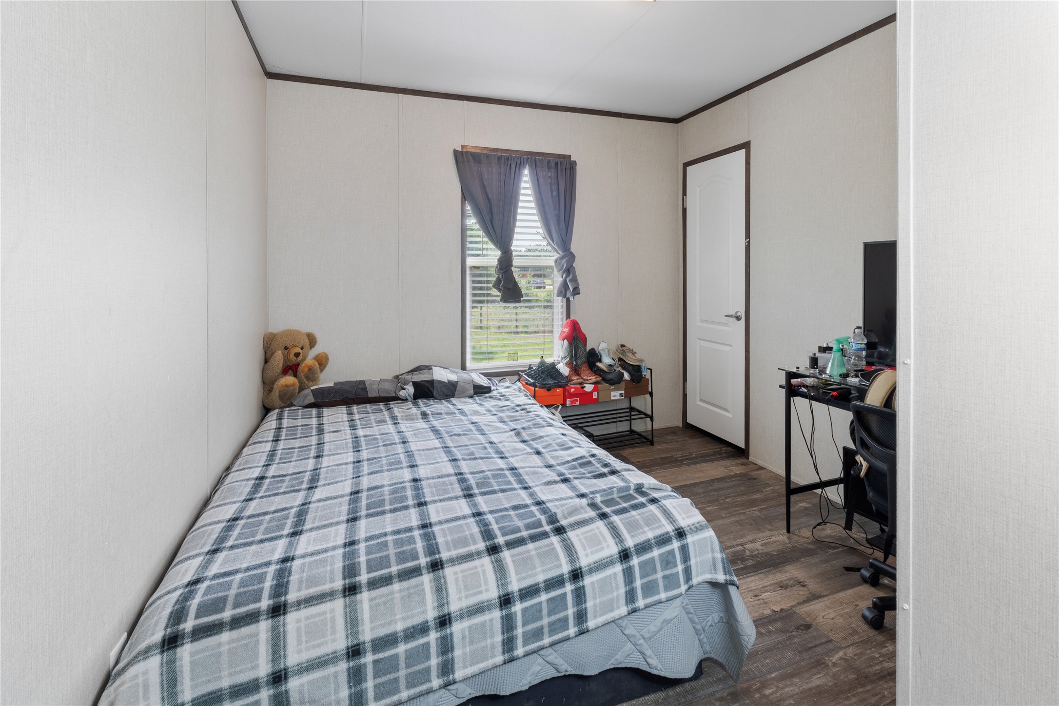 109 Hibiscus Cove Elgin, TX 78621 - Photo 12 of 15 Comfortable bedroom retreat with durable flooring and natural light.