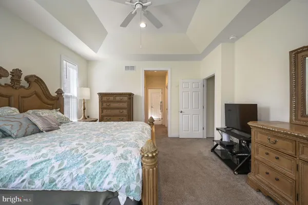 a bedroom with a bed dresser and a window