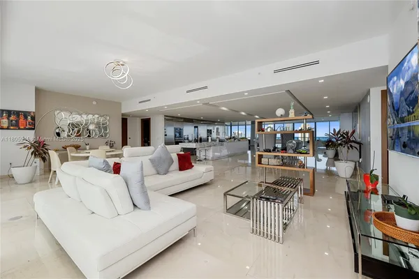 a living room with lots of furniture and white walls