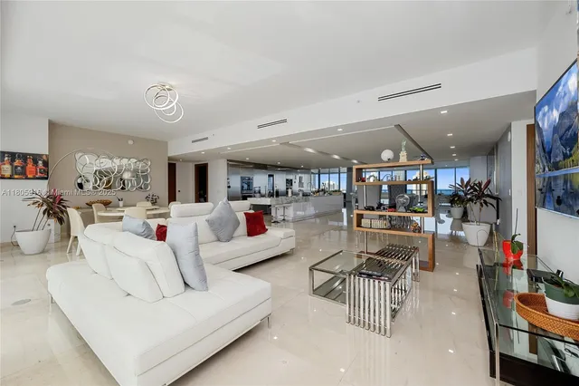 a living room with lots of furniture and white walls
