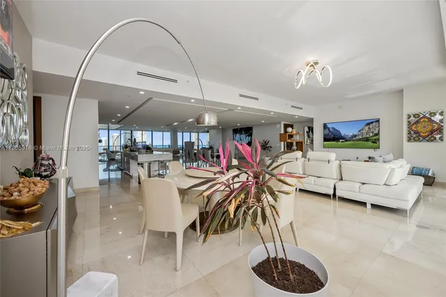 a dining room with furniture and a chandelier