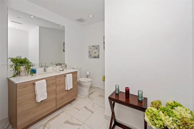 a spacious bathroom with a double vanity sink and a mirror