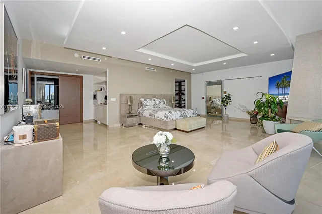 a living room with furniture flowers and a chandelier
