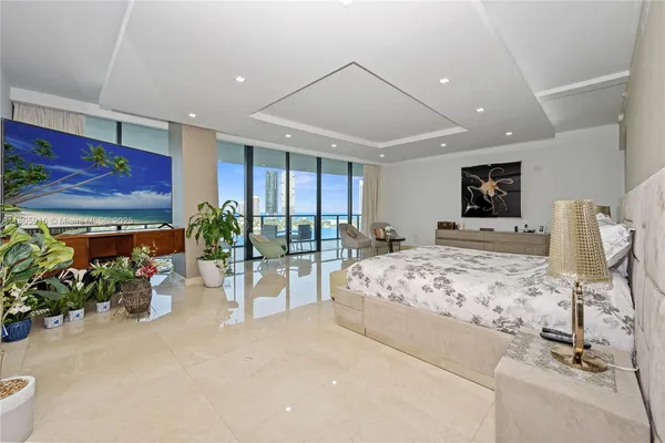 a bedroom with furniture and a large window