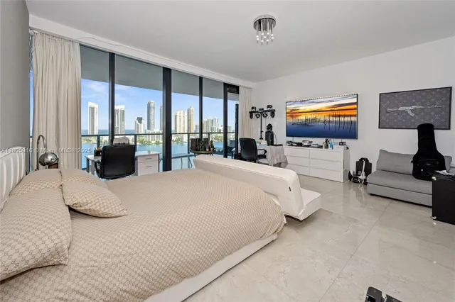 a bedroom with bed tv and window