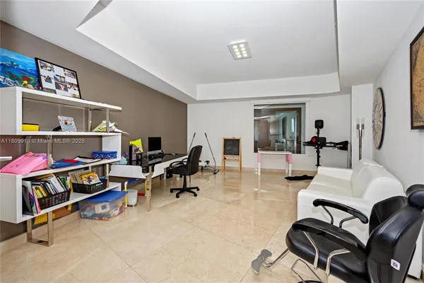 a view of a livingroom with workspace and a couch