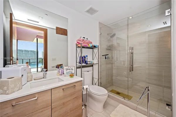 a bathroom with a sink mirror toilet and shower
