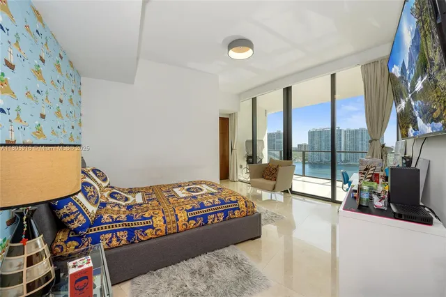 a bedroom with a bed and large window