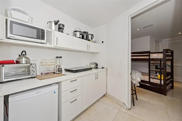 a kitchen with cabinets and window