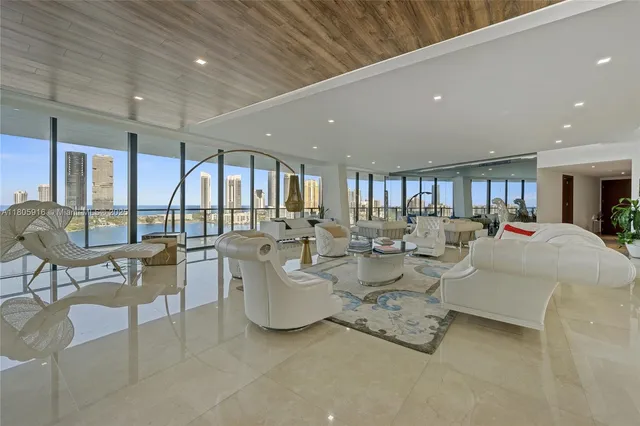 a living room with fireplace furniture and a large window