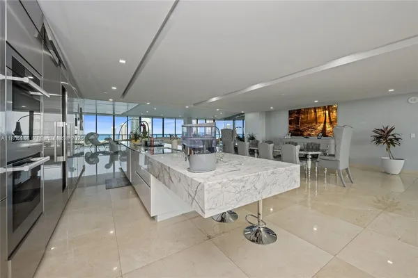 a living room with lots of furniture and kitchen view