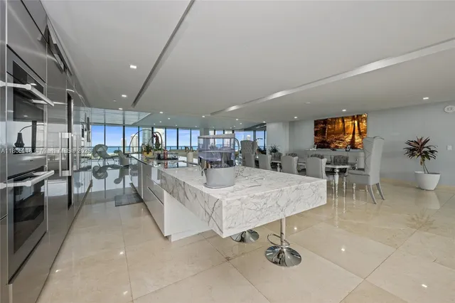 a living room with lots of furniture and kitchen view