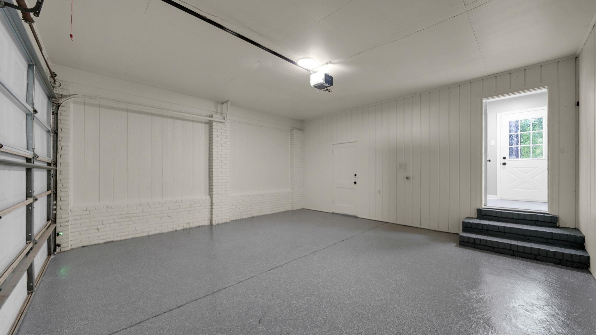 5256 Collingwood Road Memphis, TN 38117 - Photo 39 of 40 Garage with wooden walls and a garage door opener