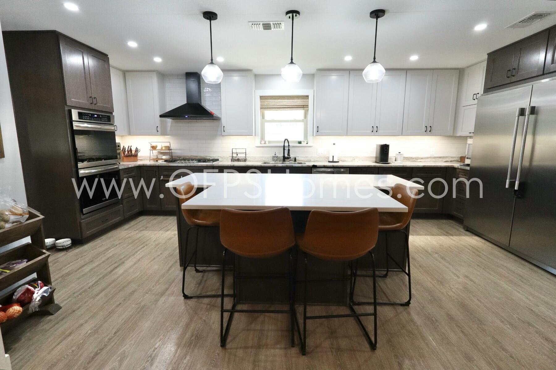 724 Overbrook Drive Fort Walton Beach, FL 32547 - Photo 11 of 47 an open kitchen with granite countertop kitchen island wooden floor center island and stainless steel appliances