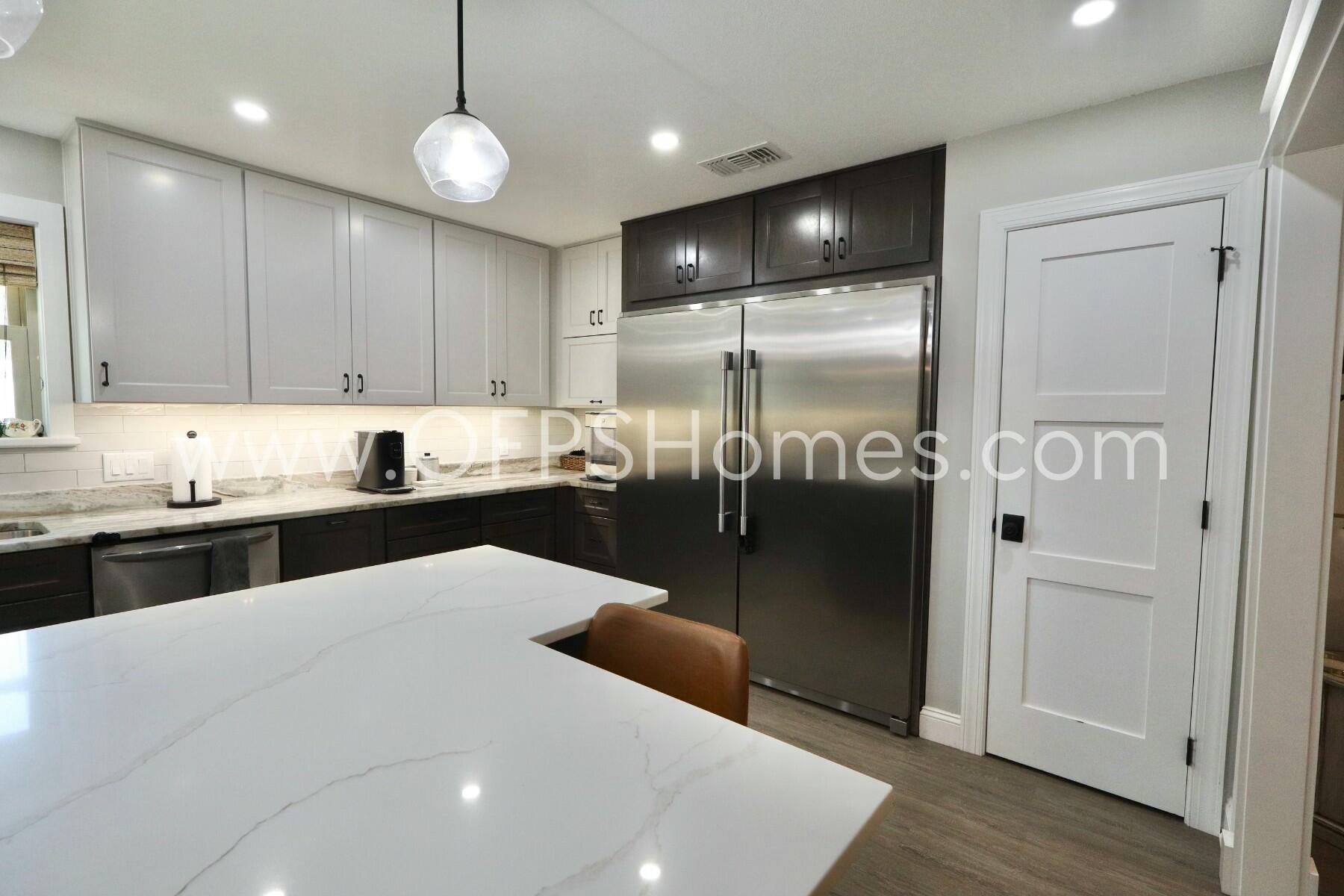 724 Overbrook Drive Fort Walton Beach, FL 32547 - Photo 12 of 47 a kitchen with stainless steel appliances granite countertop a refrigerator a sink and a stove top oven with wooden floor