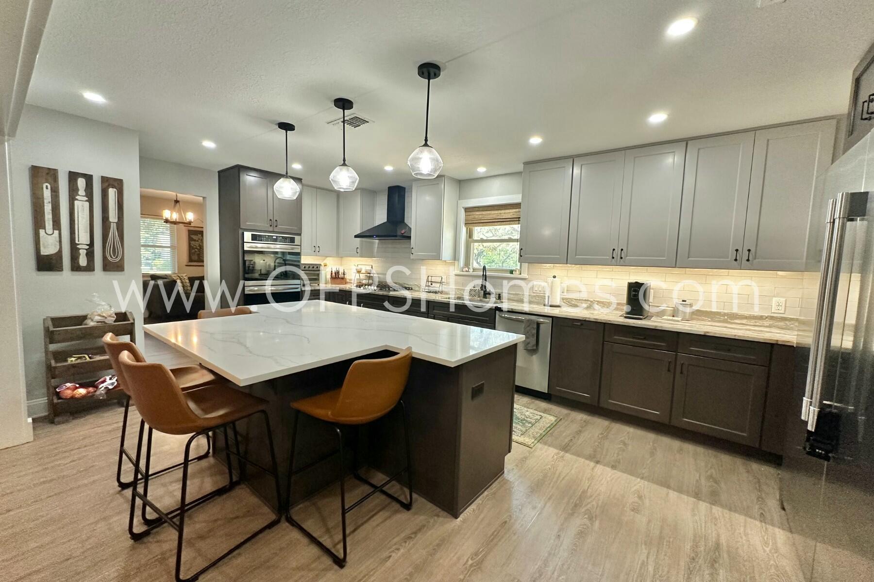 724 Overbrook Drive Fort Walton Beach, FL 32547 - Photo 17 of 47 a kitchen with a dining table chairs sink and wooden floor