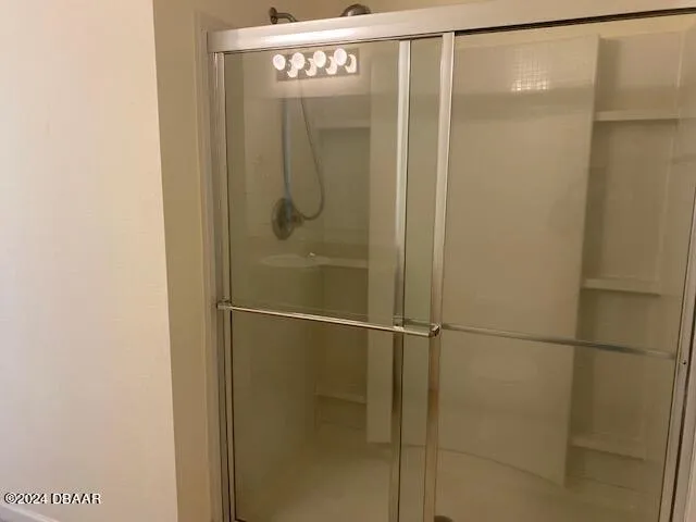a bathroom with a glass shower door