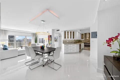 a room with a granite countertop cabinets and washer