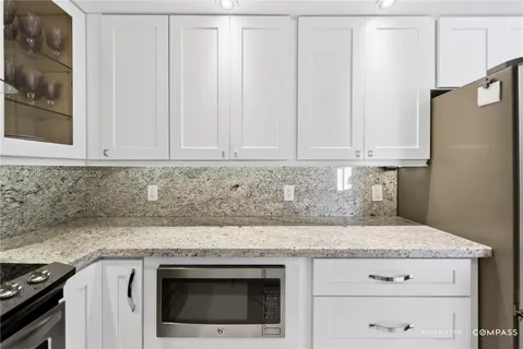 a kitchen with refrigerator and cabinets