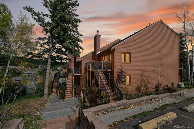a view of a house with wooden fence
