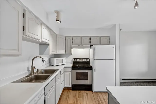 a kitchen with a sink cabinets and stainless steel appliances