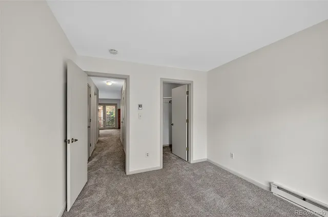 an empty room with mirror in it