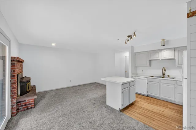 a kitchen with a sink stove and refrigerator
