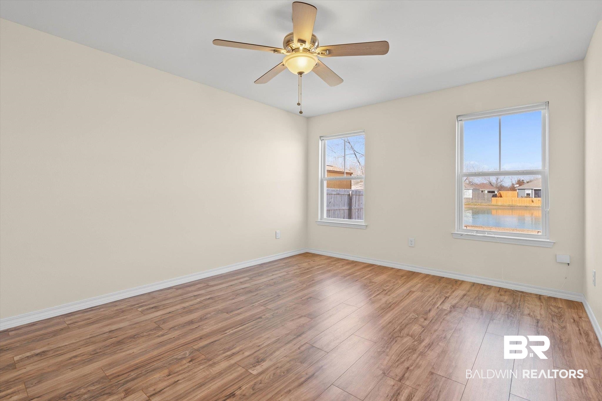919 Sailor Circle Foley, AL 36535 - Photo 11 of 24 Spare room featuring light wood-type flooring, a ceiling fan, and a water view