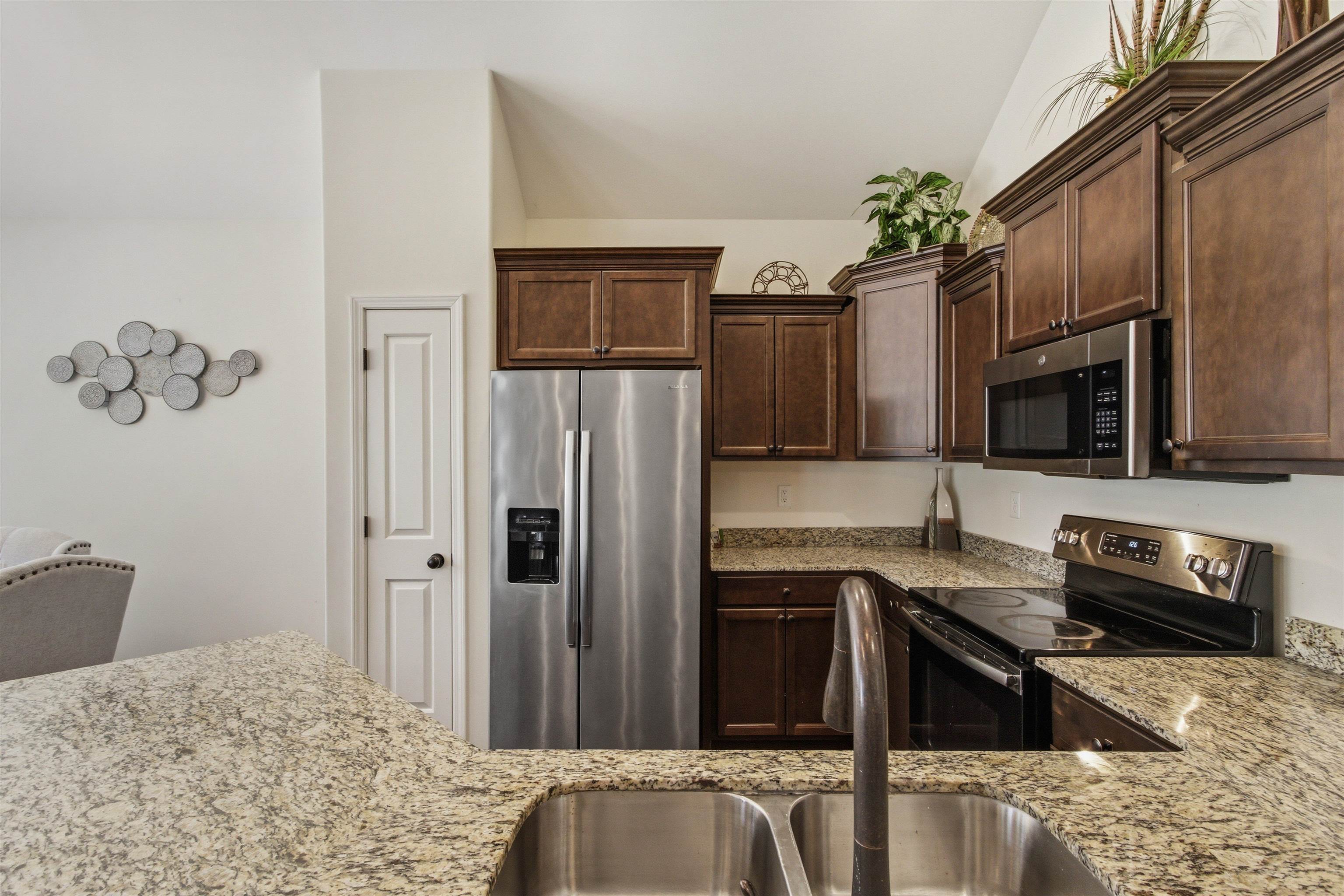 4996 Granite Creek Road Memphis, TN 38125 - Photo 12 of 37 a kitchen with a refrigerator and a sink
