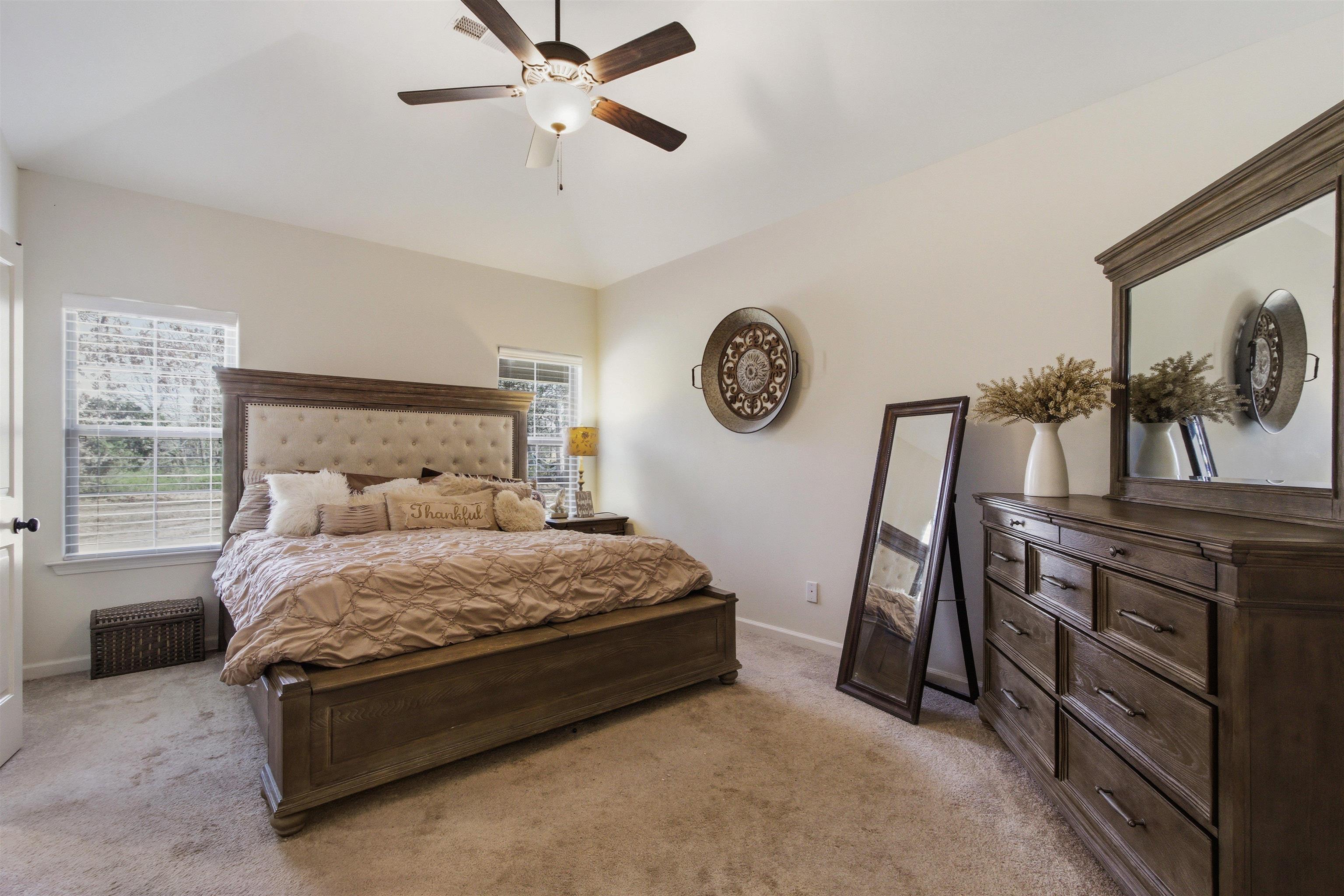 4996 Granite Creek Road Memphis, TN 38125 - Photo 15 of 37 a bedroom with a bed and a chandelier