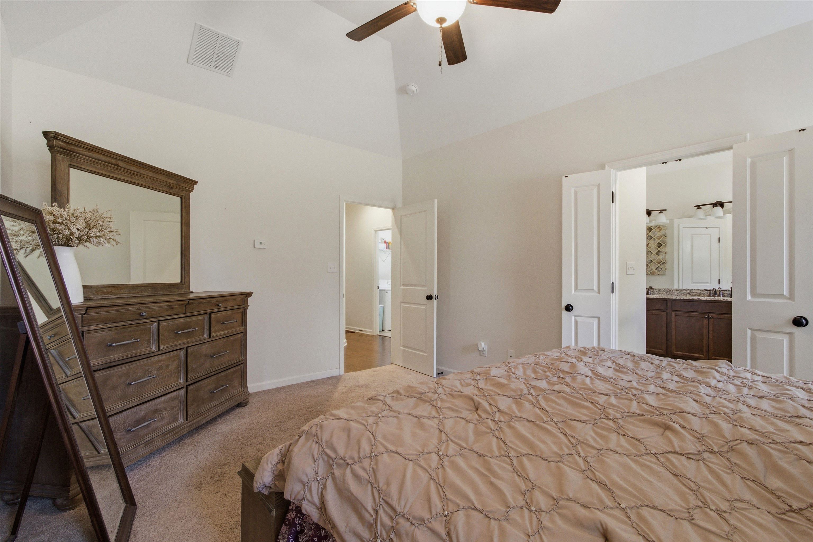 4996 Granite Creek Road Memphis, TN 38125 - Photo 16 of 37 a bedroom with a bed and a dresser