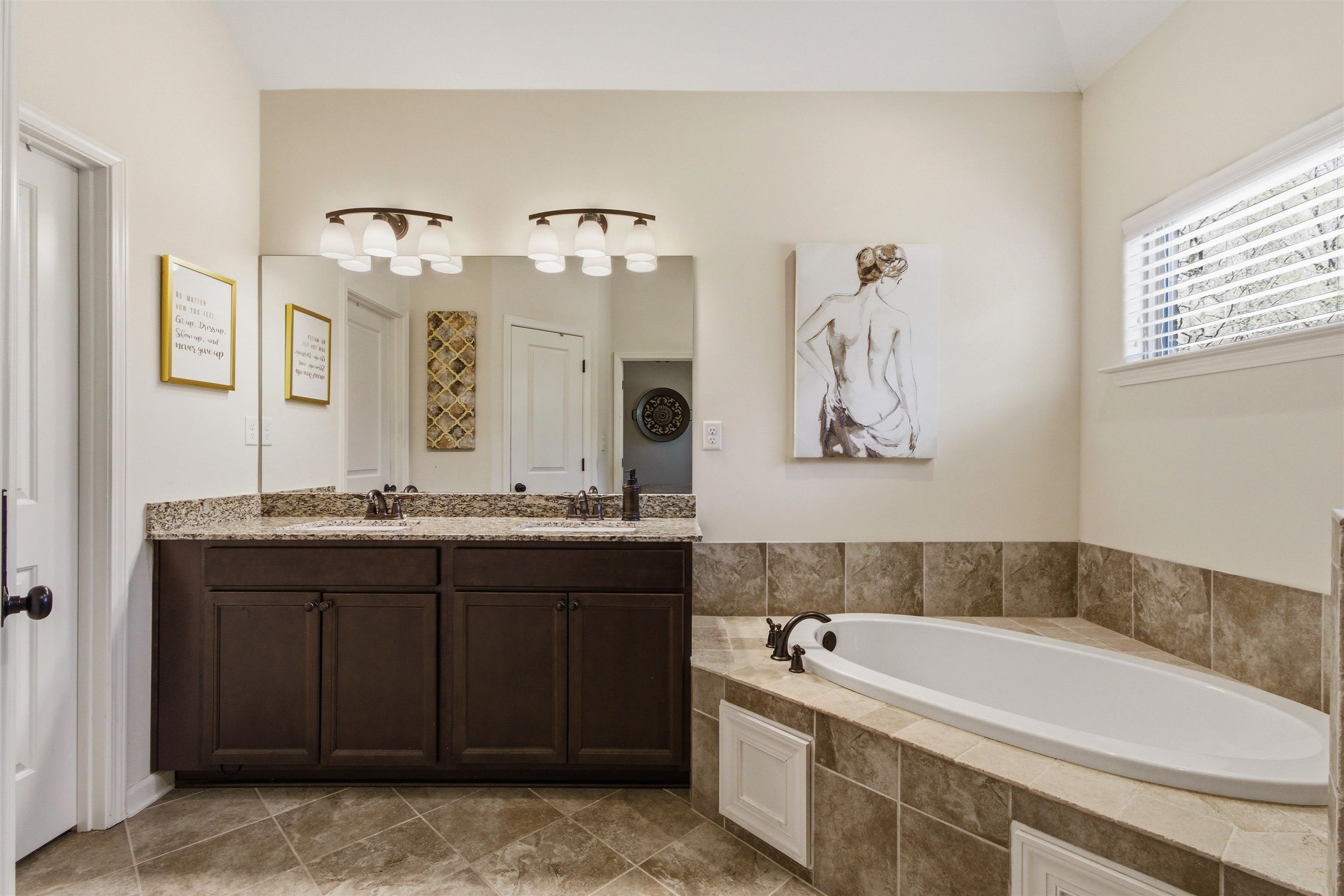 4996 Granite Creek Road Memphis, TN 38125 - Photo 17 of 37 a bathroom with a bathtub sink and mirror