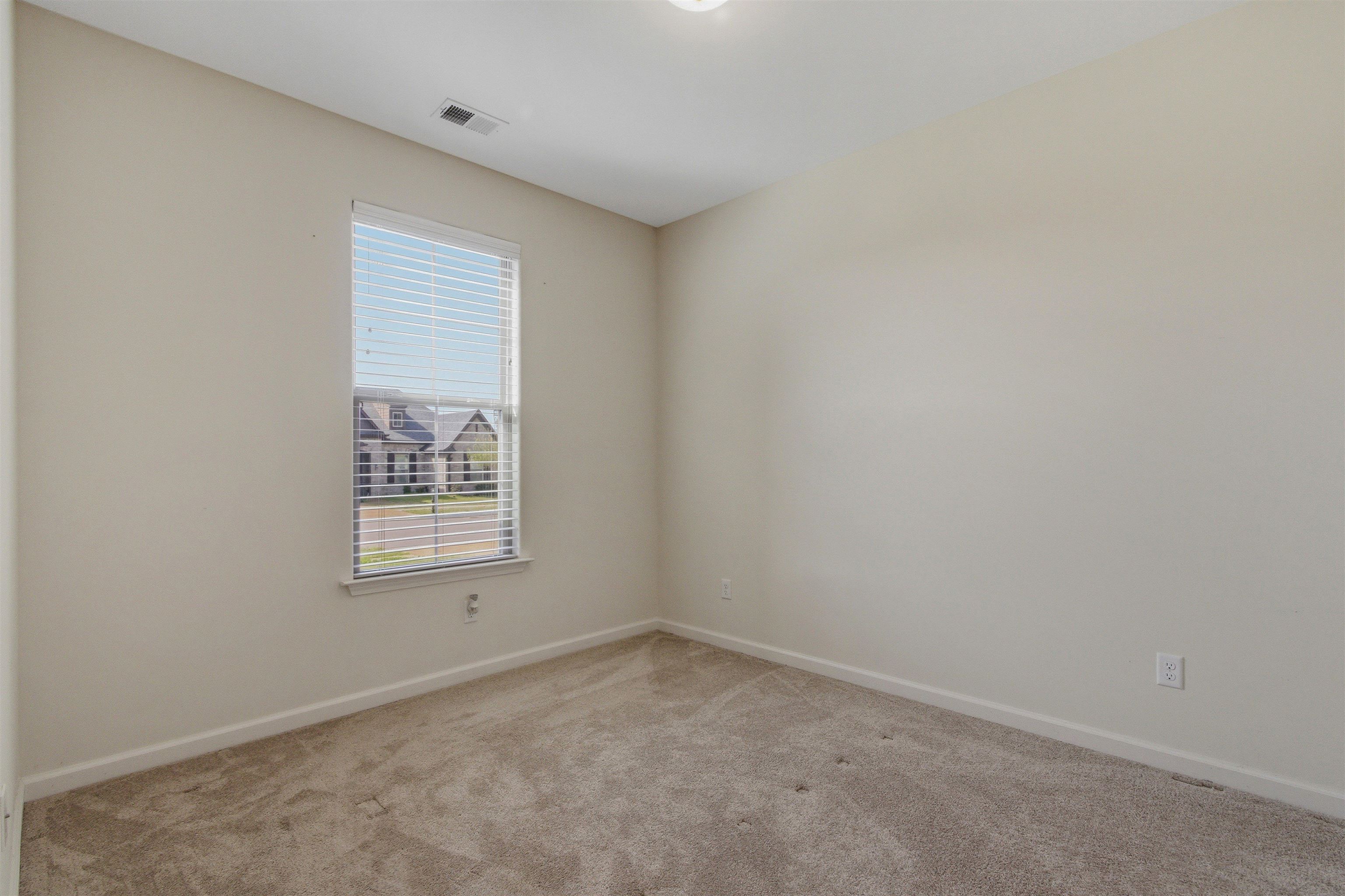 4996 Granite Creek Road Memphis, TN 38125 - Photo 19 of 37 an empty room with a window