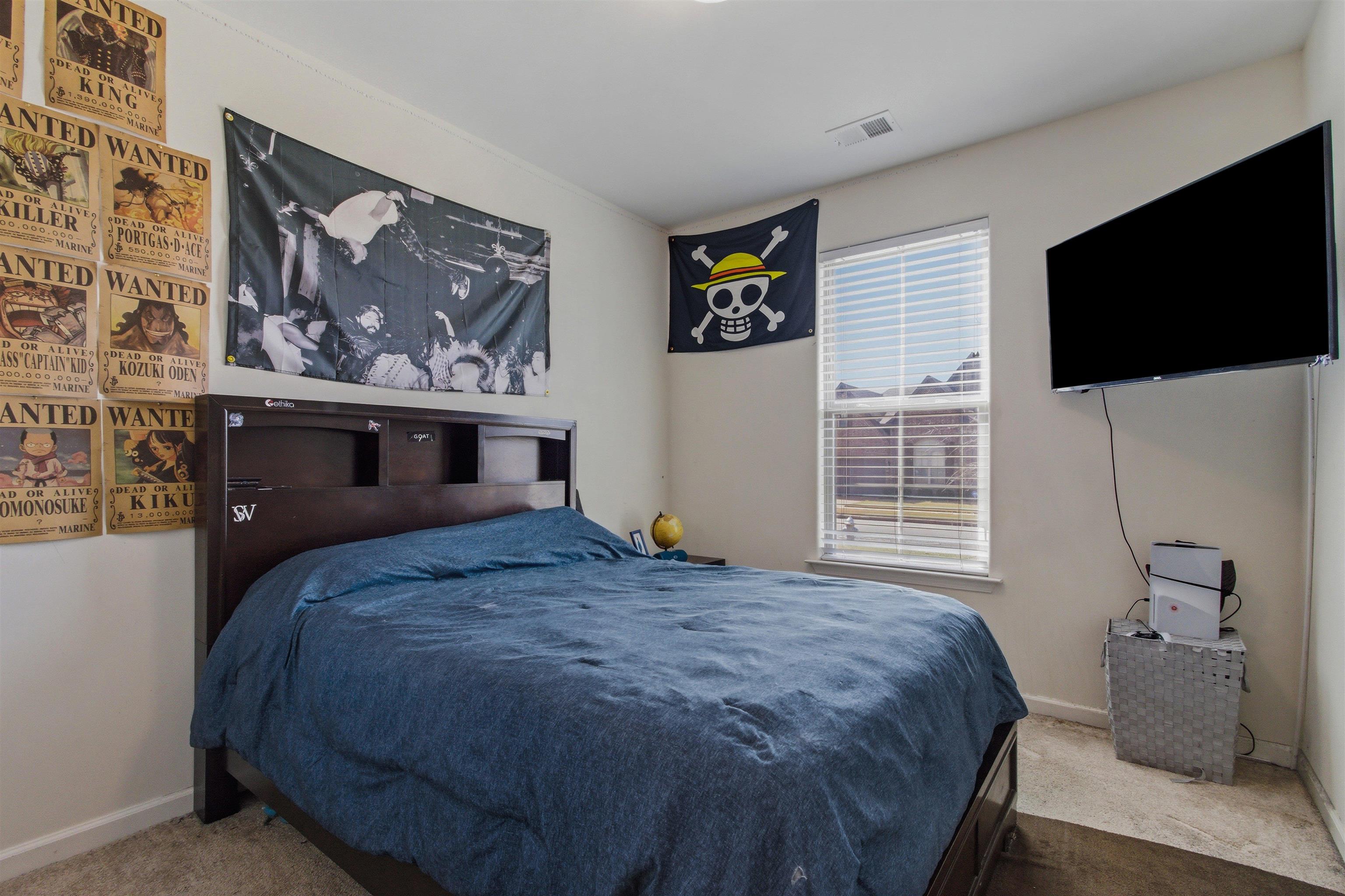 4996 Granite Creek Road Memphis, TN 38125 - Photo 21 of 37 a bedroom with a bed and a flat screen tv