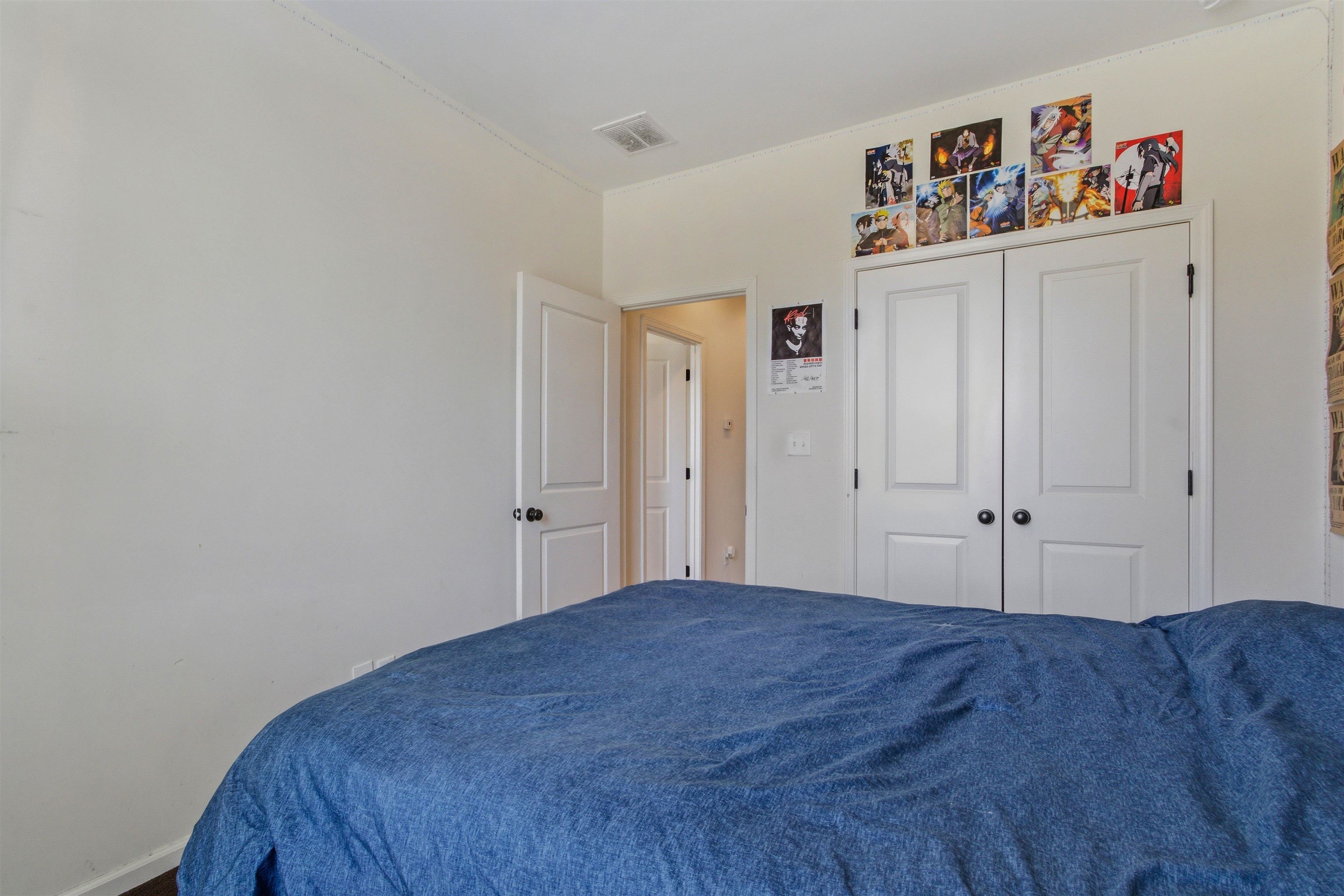 4996 Granite Creek Road Memphis, TN 38125 - Photo 22 of 37 a bedroom with a bed and a painting on the wall