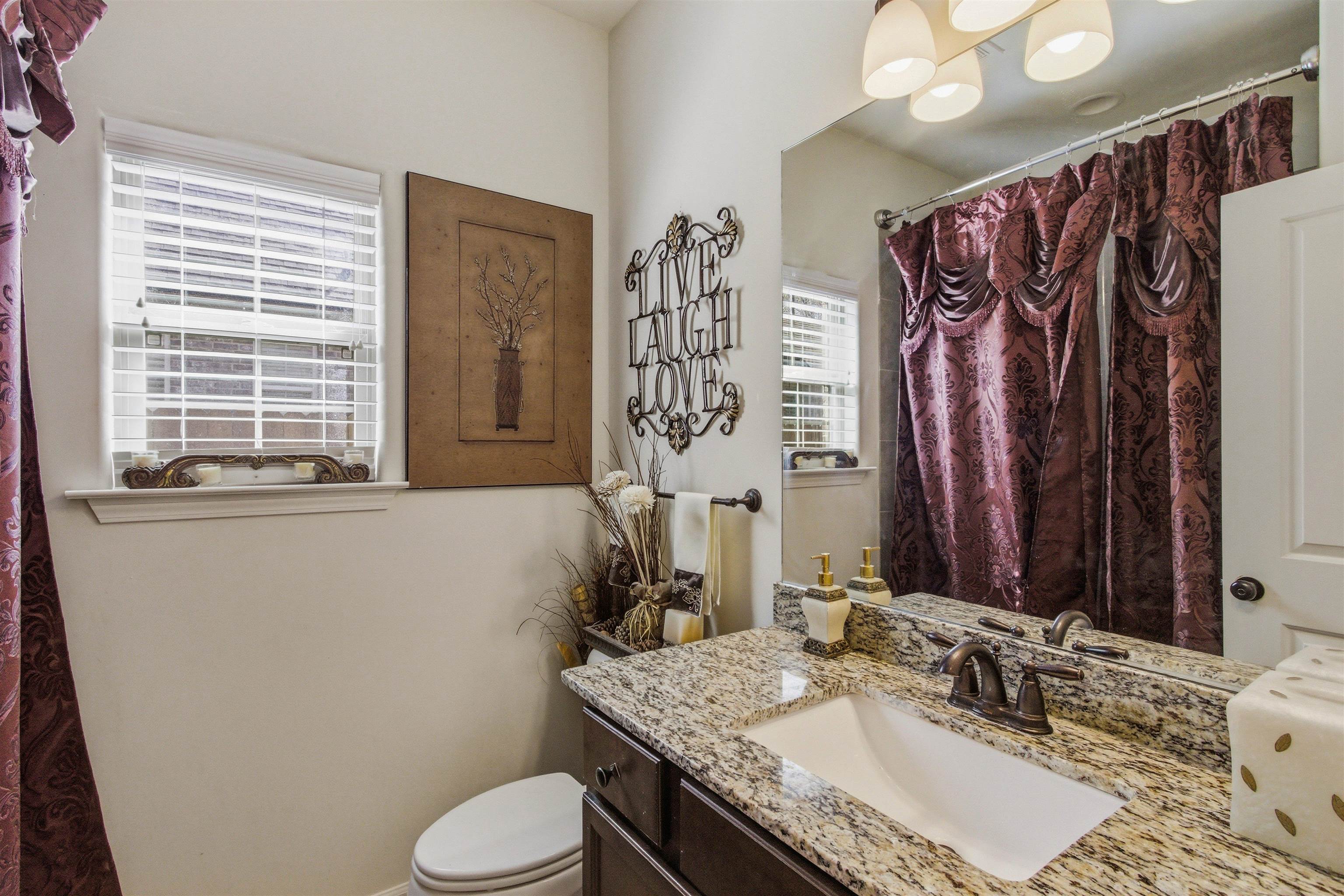 4996 Granite Creek Road Memphis, TN 38125 - Photo 23 of 37 a bathroom with a granite countertop sink toilet and shower