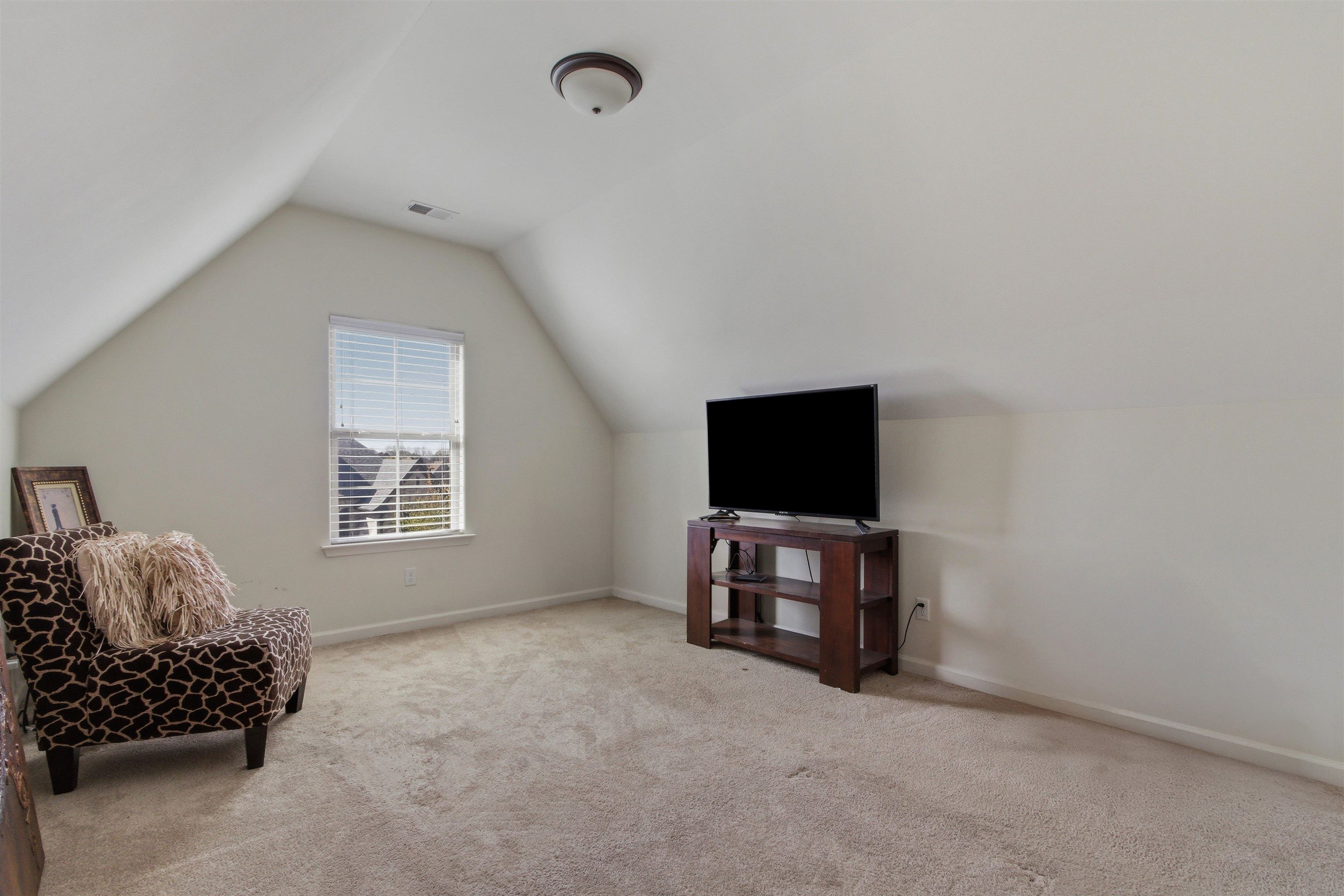 4996 Granite Creek Road Memphis, TN 38125 - Photo 24 of 37 a living room with furniture and a flat screen tv