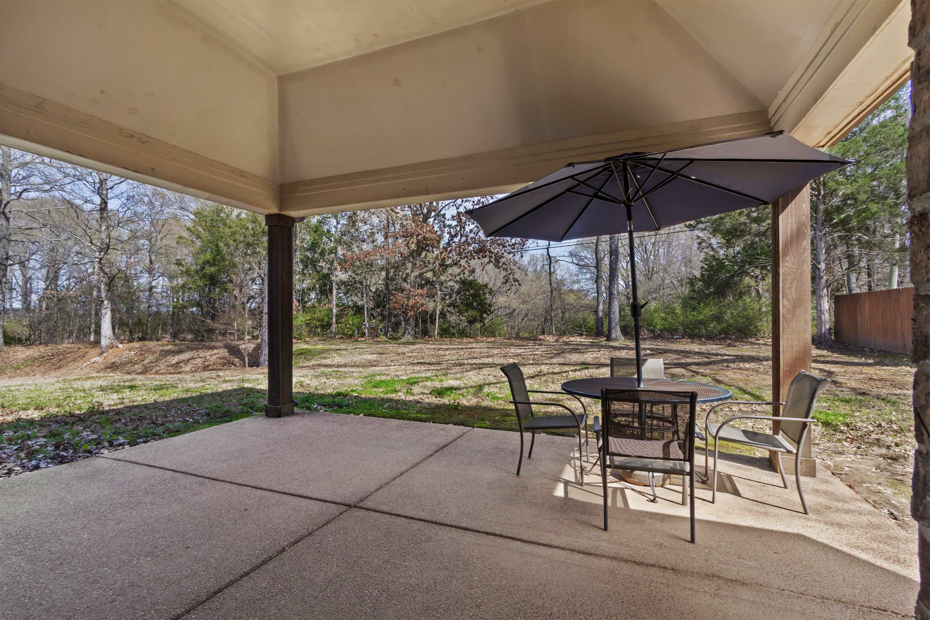 4996 Granite Creek Road Memphis, TN 38125 - Photo 26 of 37 a view of chair and table under an umbrella