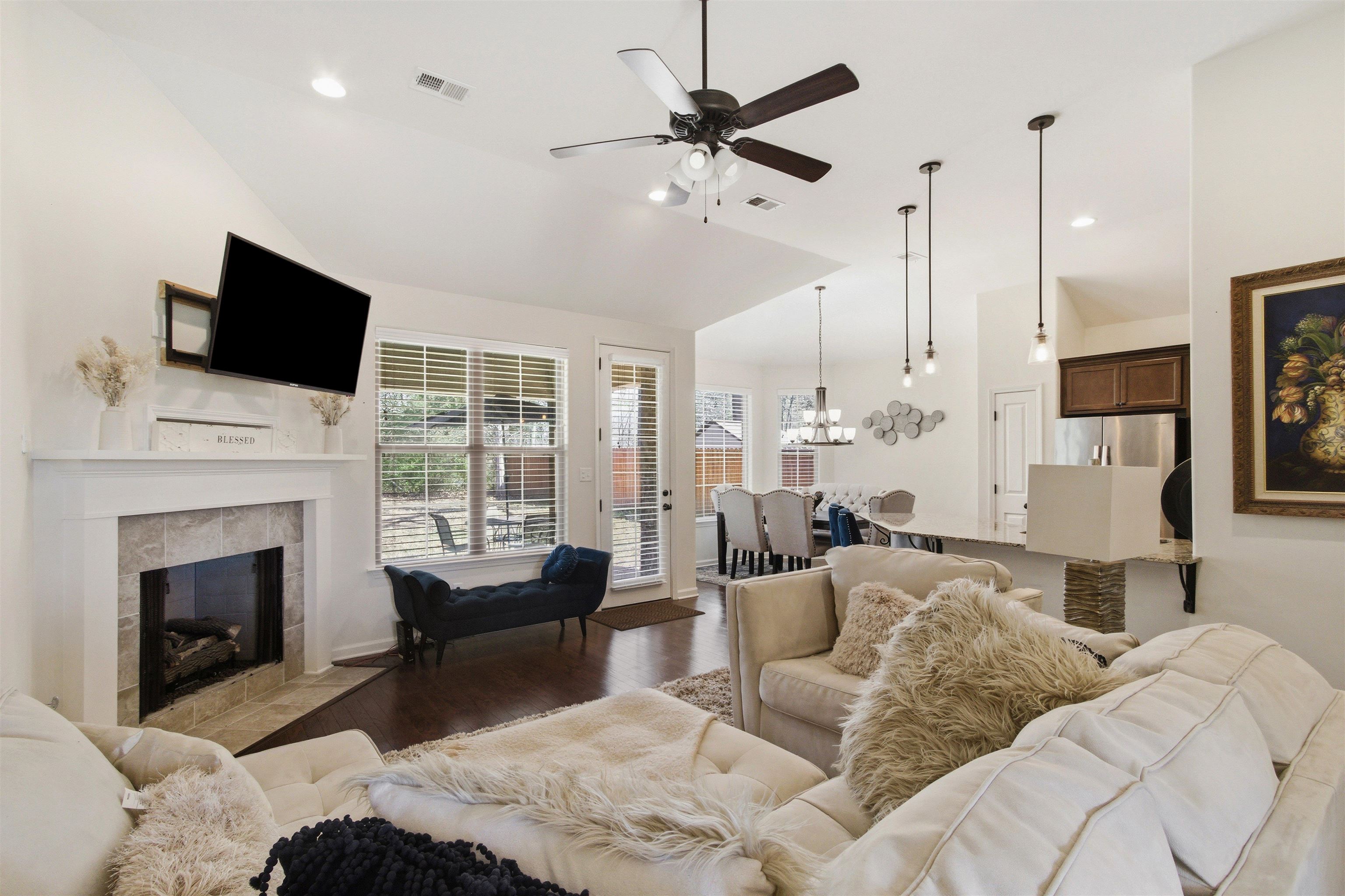 4996 Granite Creek Road Memphis, TN 38125 - Photo 6 of 37 a living room with furniture a fireplace and a flat screen tv