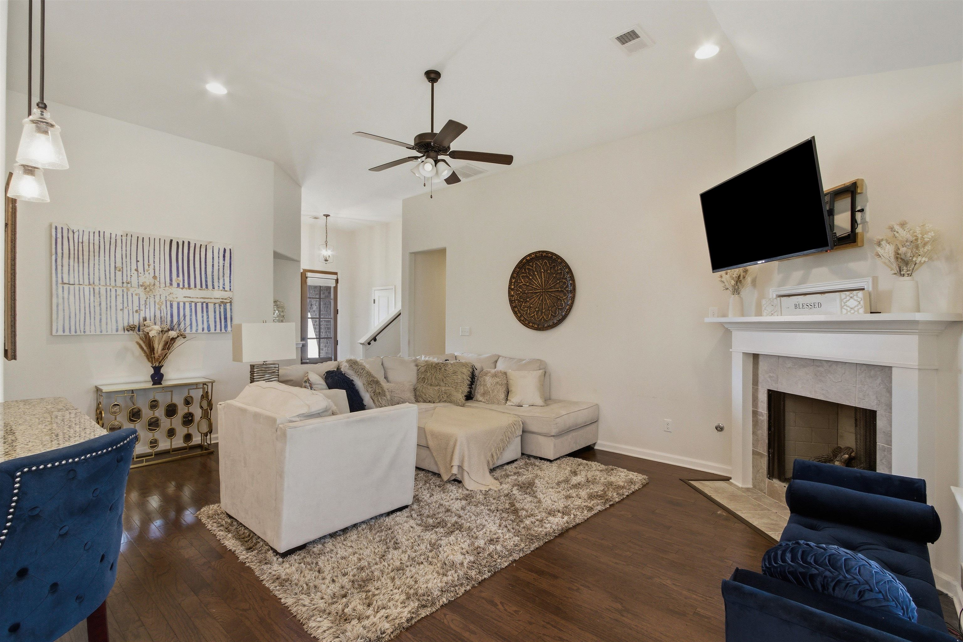 4996 Granite Creek Road Memphis, TN 38125 - Photo 7 of 37 a living room with furniture a fireplace and a flat screen tv